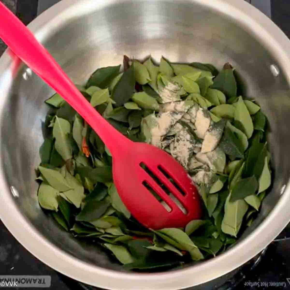 adding curry leaves and asafoetida