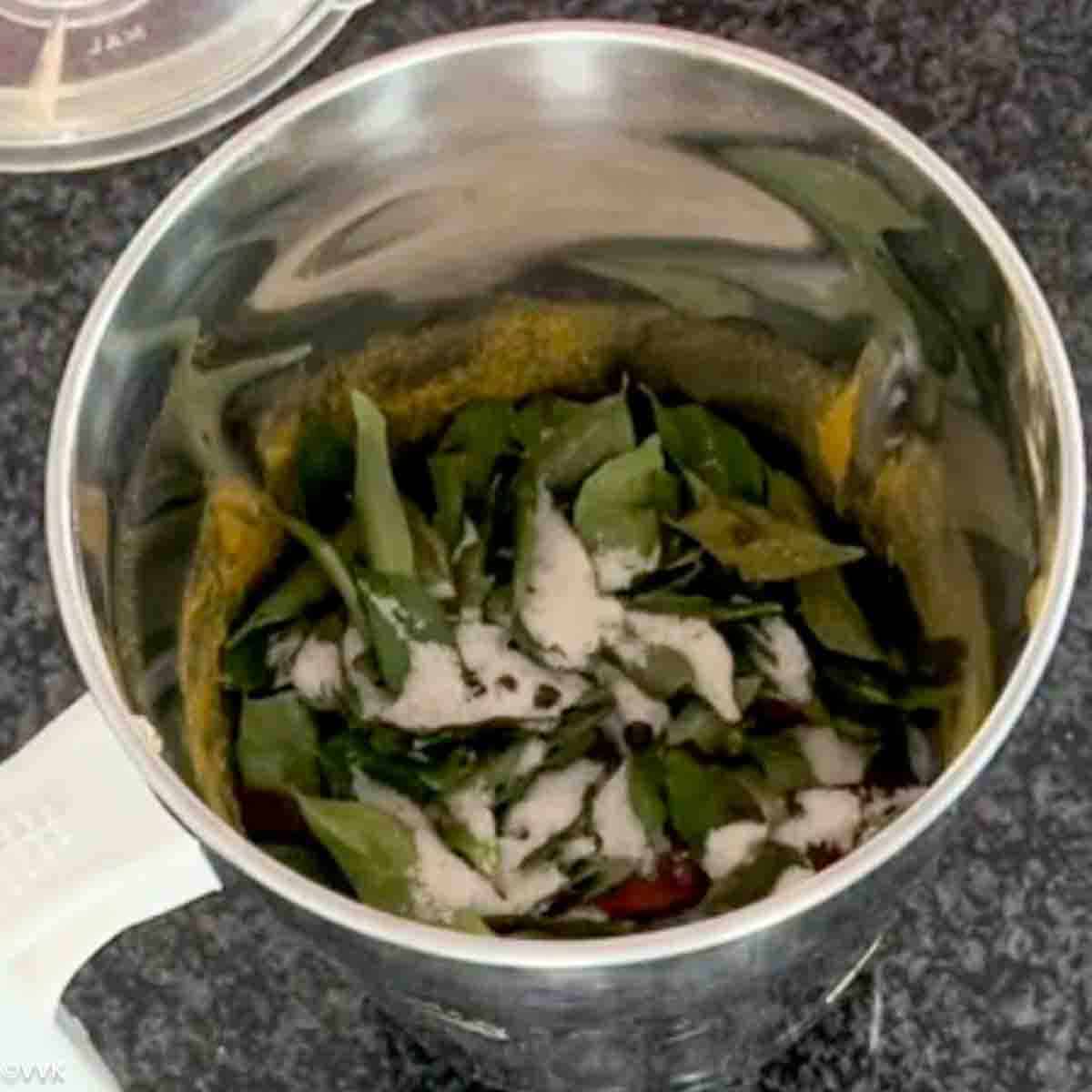 grinding the currleaves with spices and salt