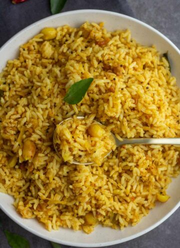 square image of raw mango rice served in white plate with spoonful of rice