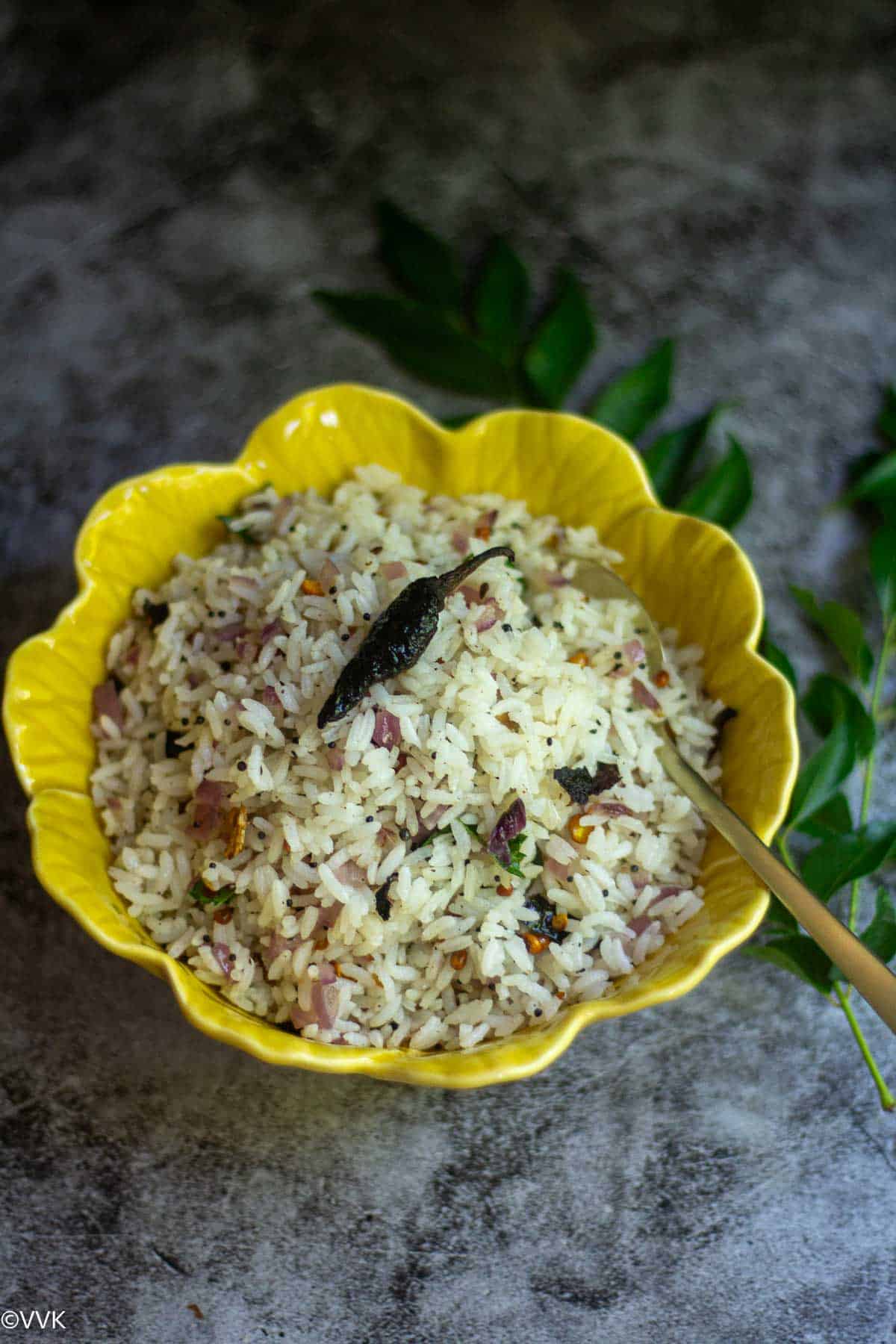 Thalicha sadam in the yellow bowl with spoon inside