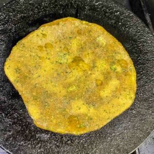 cooking the paratha on first side