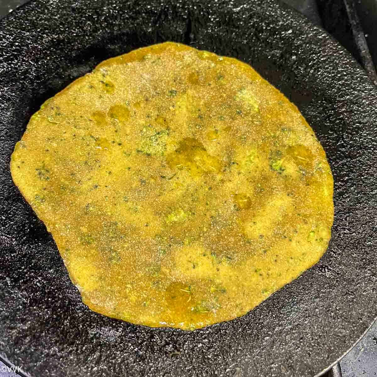 cooking the paratha on first side