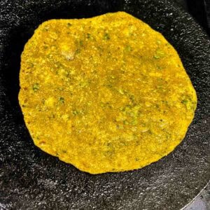 flipping the paratha and cooking