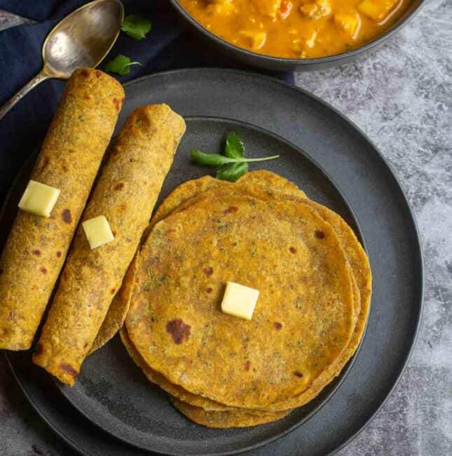 square image overhead shot of broccoli paratha shot and rolled ones on the side