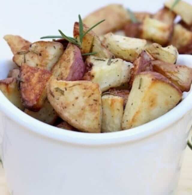 Oven Roasted Rosemary Potatoes served in a white bowl and a white casserole