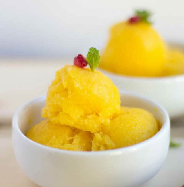 Tropical Sorbet - Mango and Pineapple Sorbet Vertical Image with One Bowl in Focus and Another One Blurred in the Background