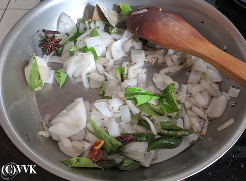 Adding the chopped onion, curry leaves and slit green chilies