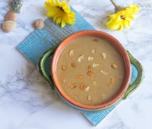 Beautiful Gasagase Payasa or Poppy Seeds Kheer ready and served with yellow flowers decorating the table