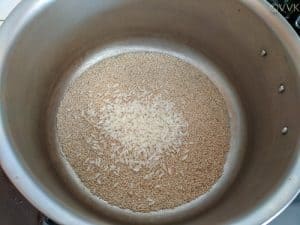 Dry roasted poppy seeds and rice in a pan or kadai