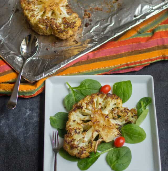 Roasted Cauliflower Steaks Overhead Shot on the Dish Served in a White Plate