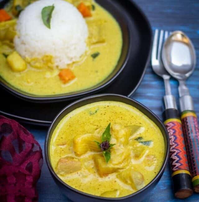 Watermelon rind thai curry in a black bowl with rice and curry on a plate on the side