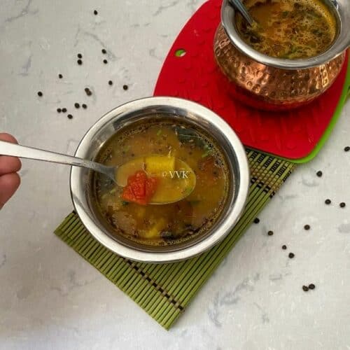 square image of pineapple rasam served in a bowl