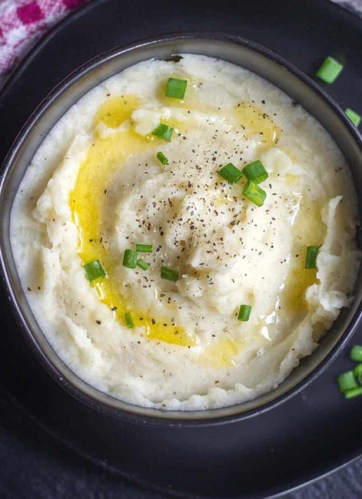 square image of mashed potato served in black bowl