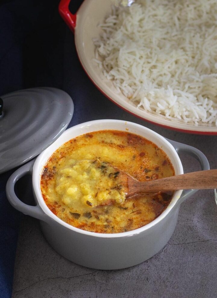 dal tadka served in a small casserole with rice