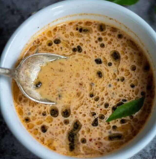 close up shot of pottukadalai chutney with spoon inside