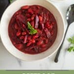 beetroot curry served in white bowl with text overlay for pinterest