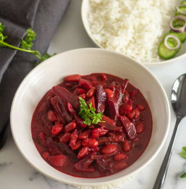 easy wholesome beet potato curry served in white bowl with side of rice and cucumber