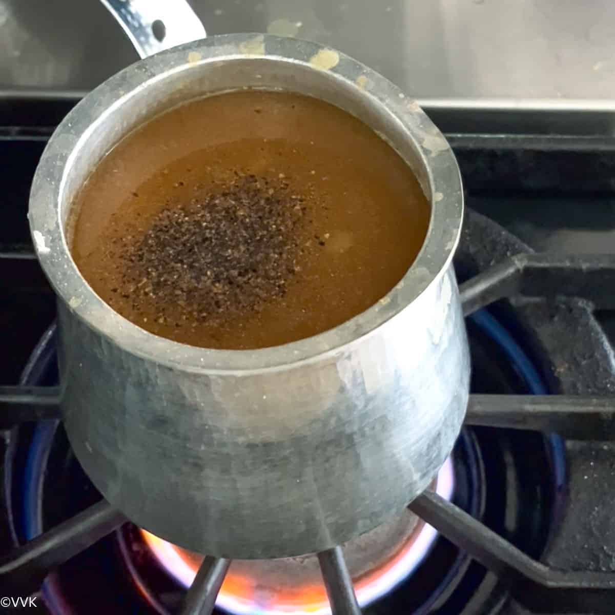 adding the dal, jaggery and pepper