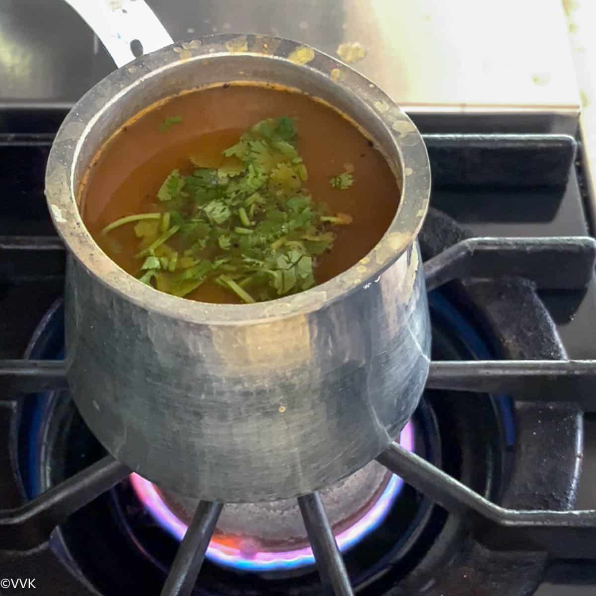 adding the cilantro and bringing it simmer