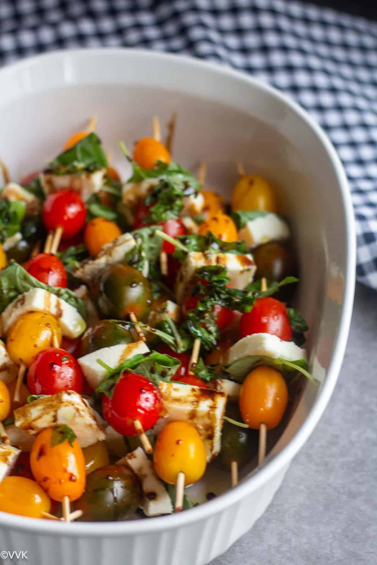 caprese skewers in white serveware