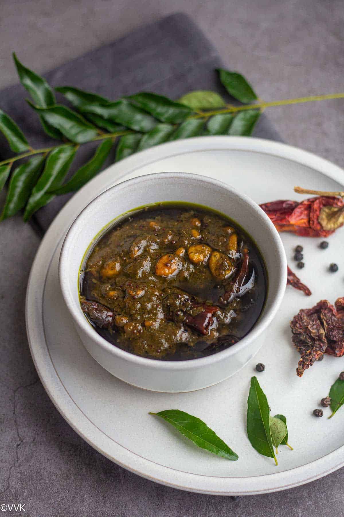 curry leaves tamarind rice paste served on a bowl placed on a plate