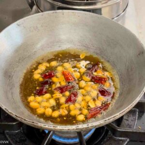 adding tamarind water and salt and turmeric