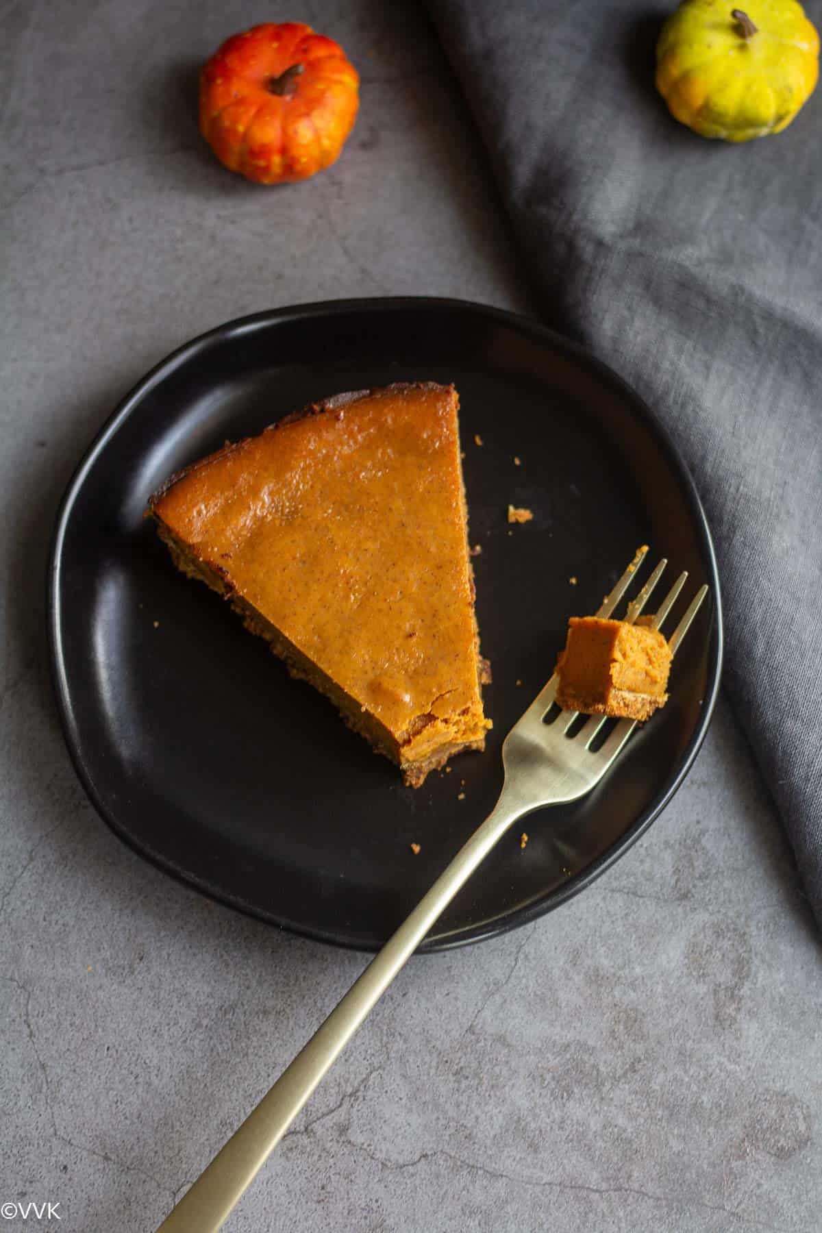 pumpkin pie with a small piece on the fork