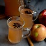 square image of apple cider served in two glasses