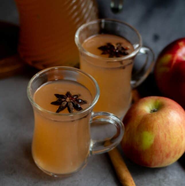 square image of apple cider served in two glasses