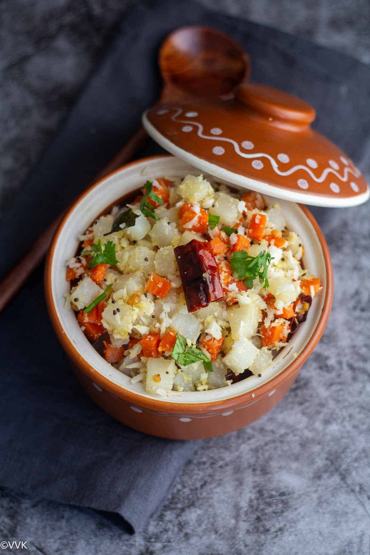 easy carrot diakon radish sitr fry in clay pot with lid on the side