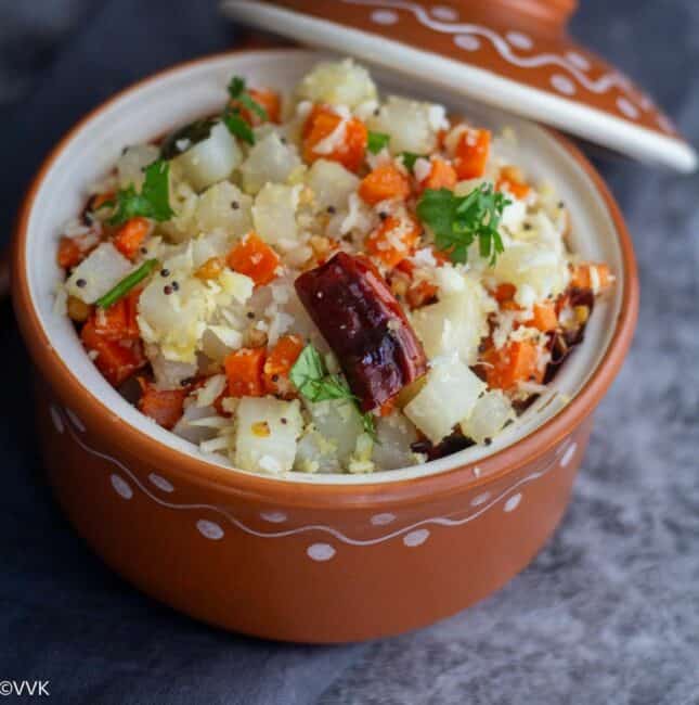 square image of carrot radish poriyal served in terracotta serveware