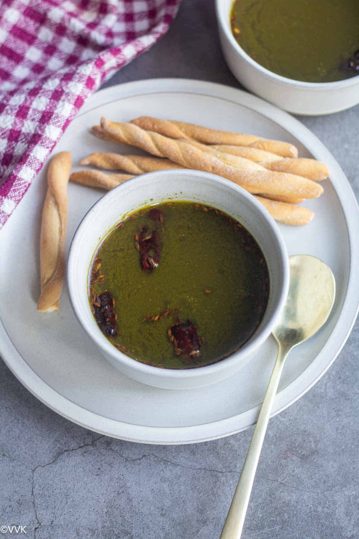 moringa leaves soup served in white bowl