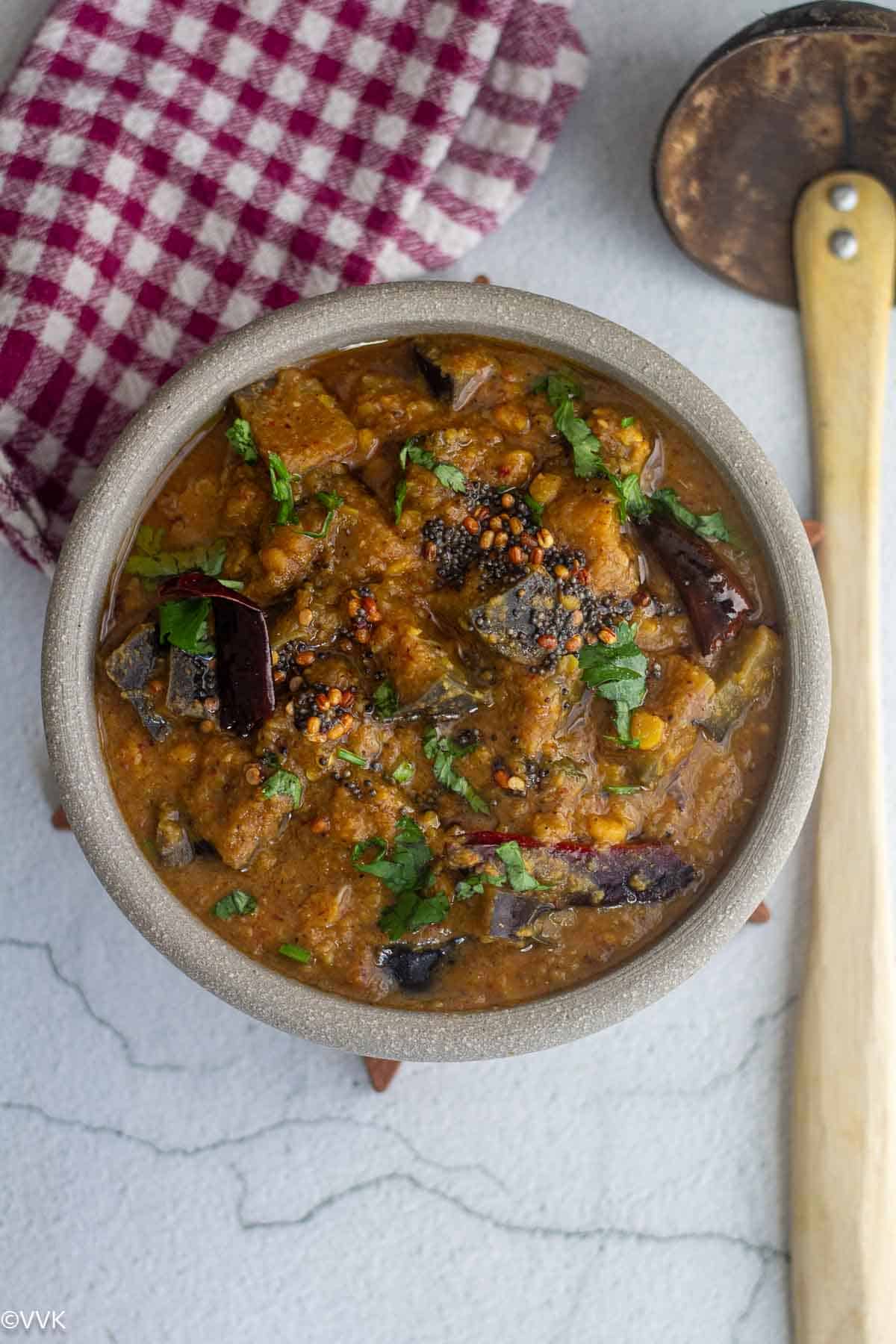 overhead shot of brinjal rasavangi served in white bowl