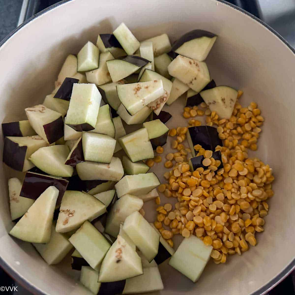 adding brinjal and chana dal to the dutch oven