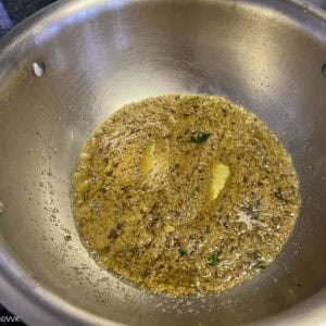 tempering the kuzhambu and sauteing the onions