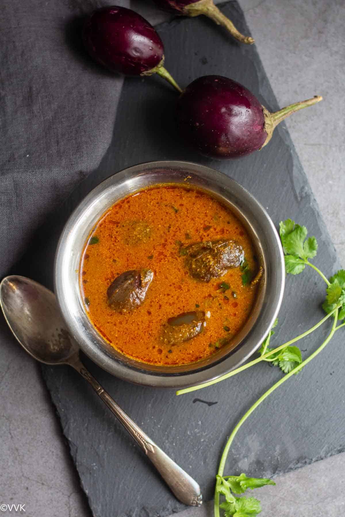 overhead shot of puli kuzhambu with brinjals