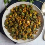 square image of okra peanut curry served in white bowl