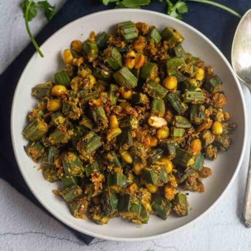 square image of okra peanut curry served in white bowl