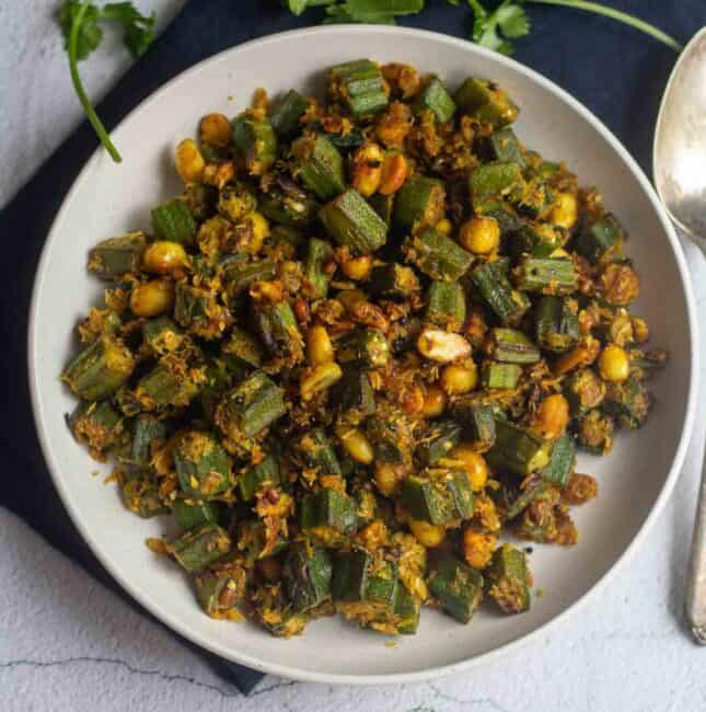 square image of okra peanut curry served in white bowl