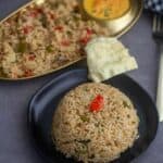 square image of potato capsicum rice served in black plate