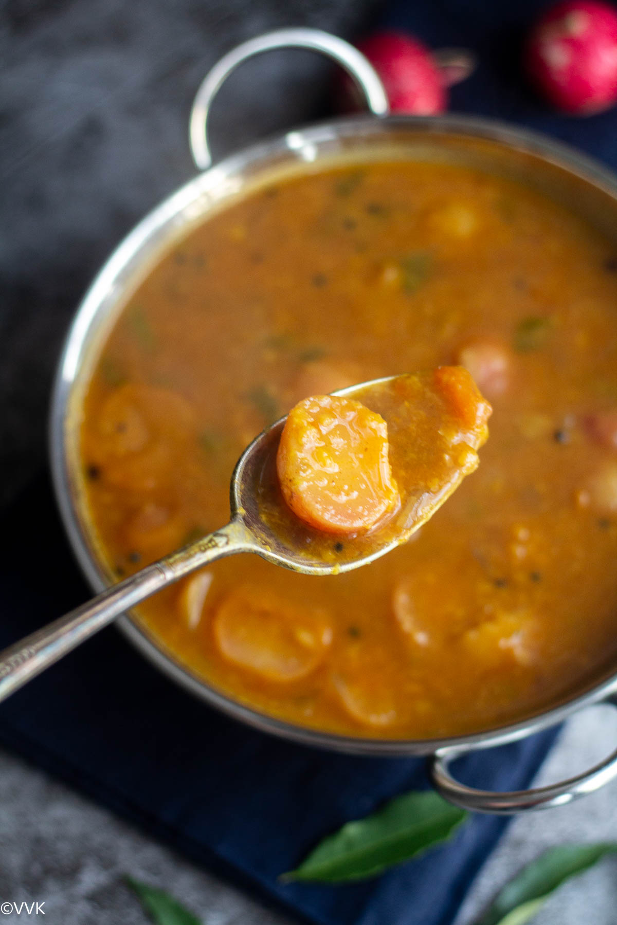 red radish sambar in kadai with spoon fulf of sambar