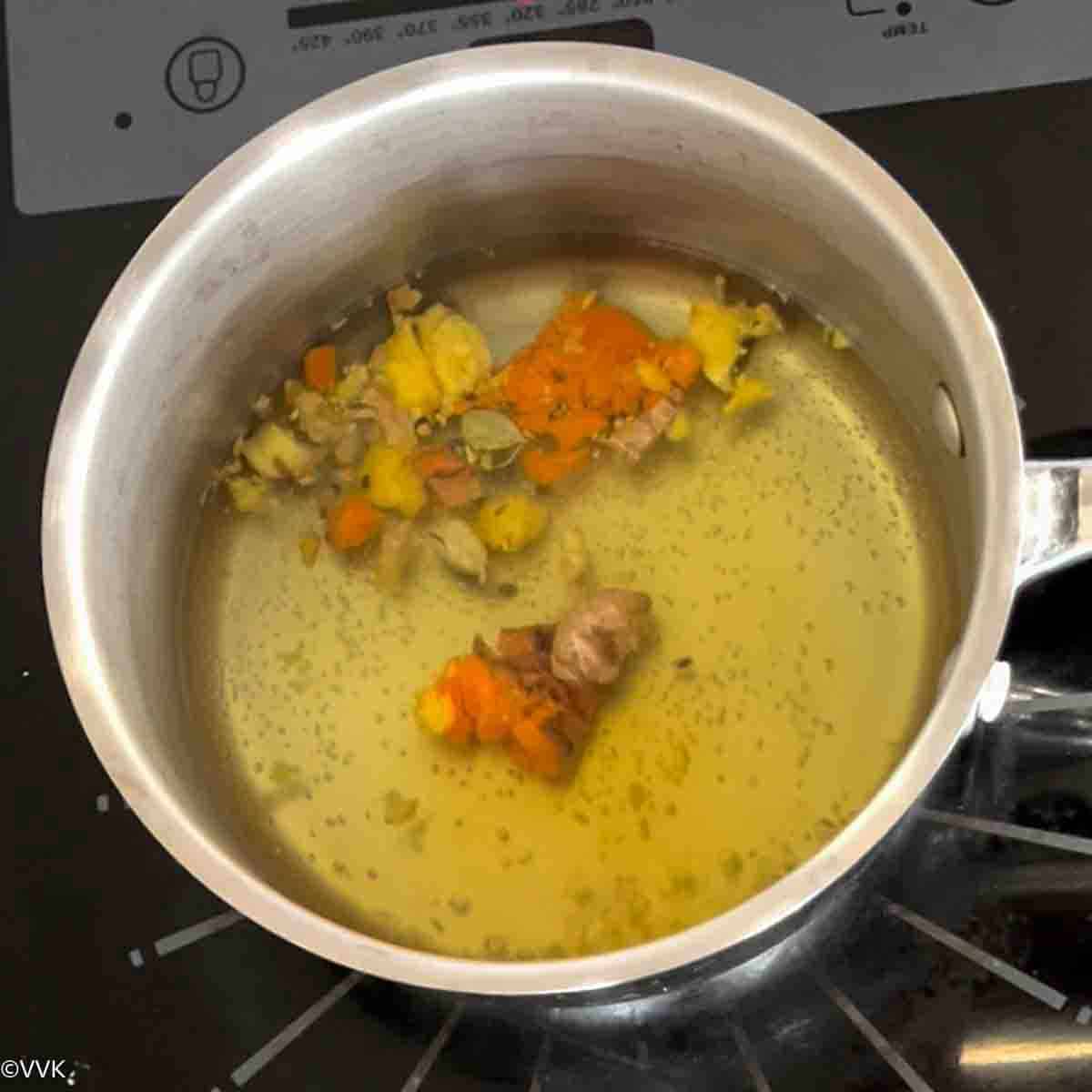 adding the crushed turmeric, ginger and cardamom