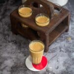 square image of ginger turmeric tea placed on a coaster