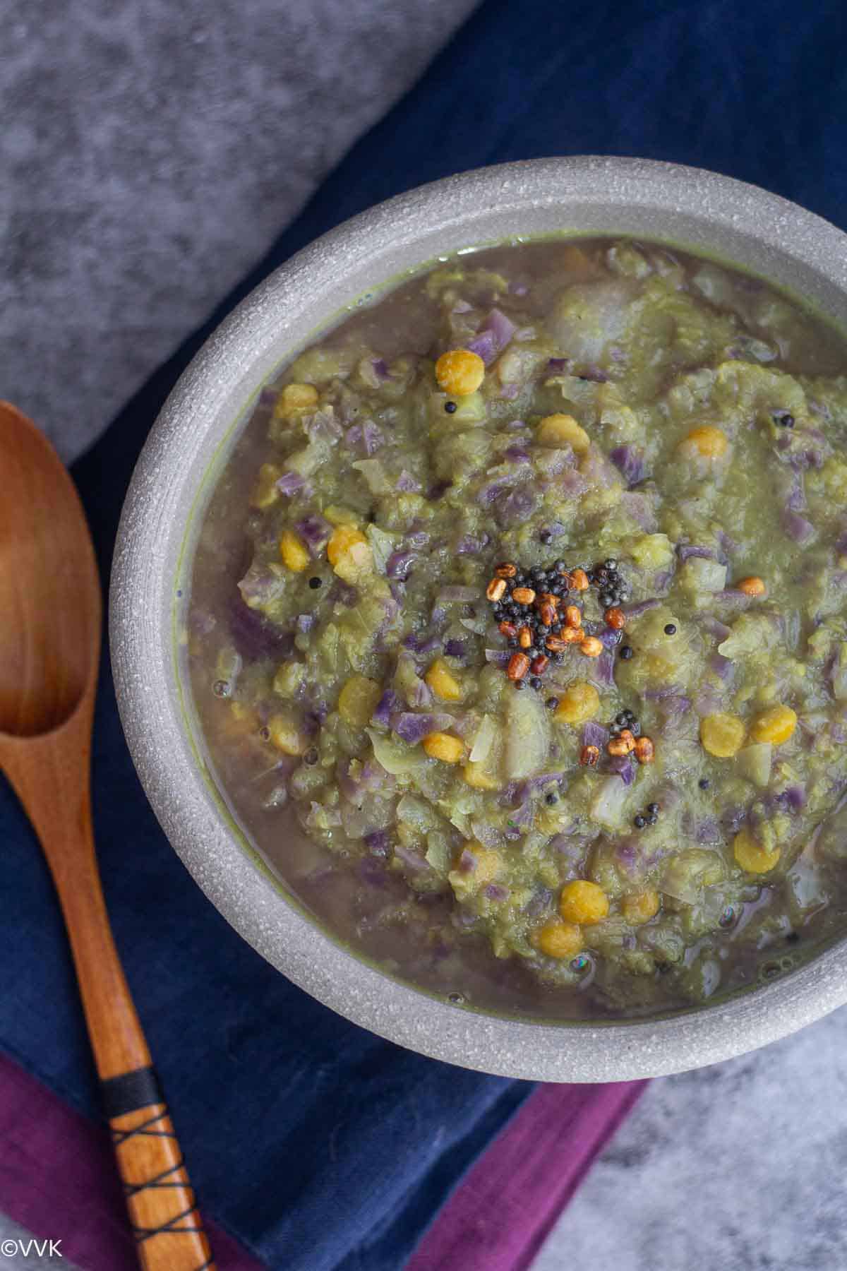 cabbage kootu topped with tempering served in clay pot