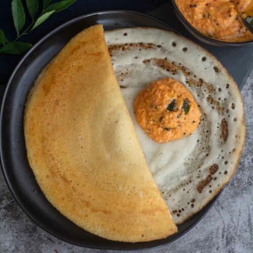 fenugreek dosa served with chutney on plate