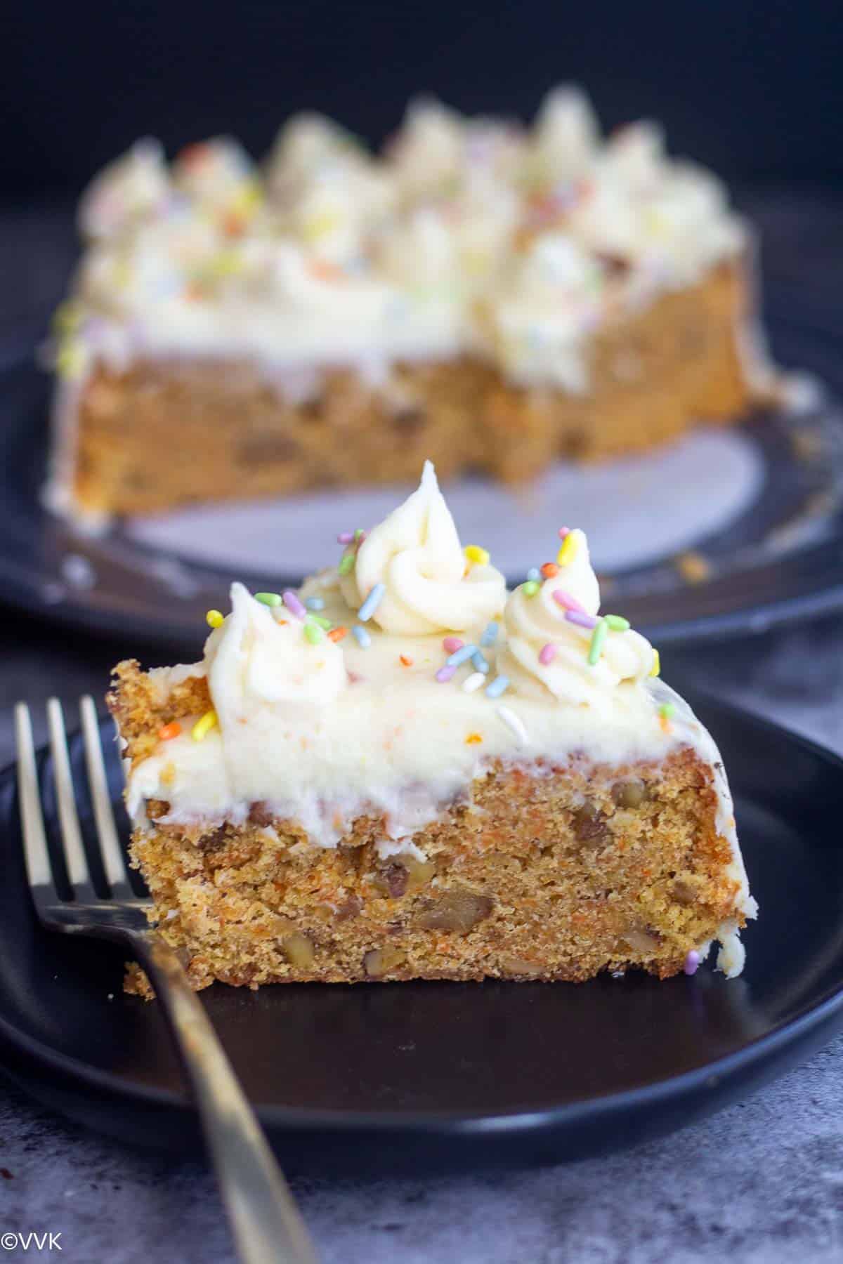 carrot cake slice with a fork on the side